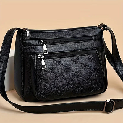 URBAN EDGE™ — BLACK CROSSBODY BAG WITH EMBOSSED GEOMETRIC PATTERN